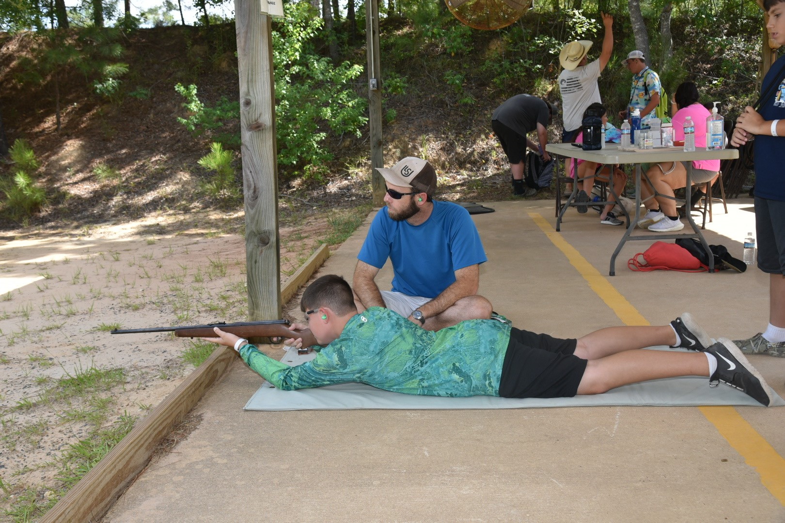 4-H youth learning to have a steady aim.
